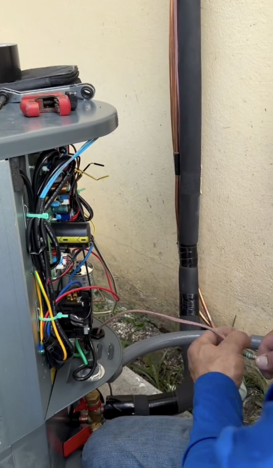 Técnico de Rocket HVACR realizando cableado de precisión en un sistema de HVAC
